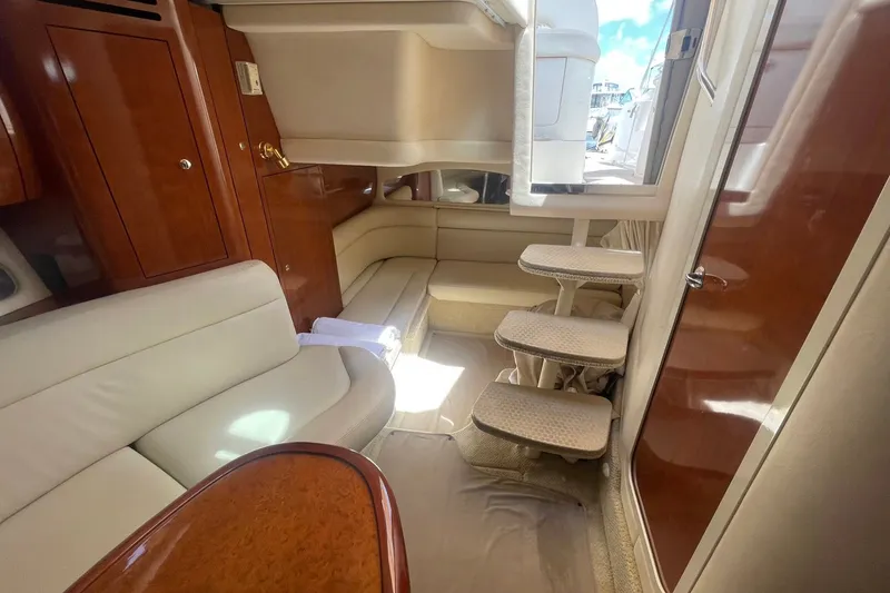 Slide: The Image of Interior of 2003 Sea Ray 360 Sundancer yacht with plush seating and wooden cabinetry. - 18