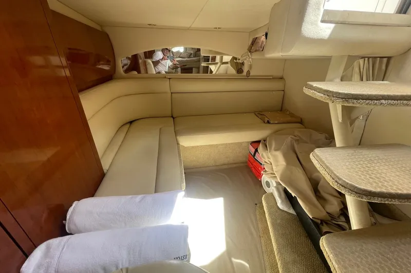 Slide: The Image of Interior of 2003 Sea Ray 360 Sundancer yacht with beige seating and wooden accents. - 23
