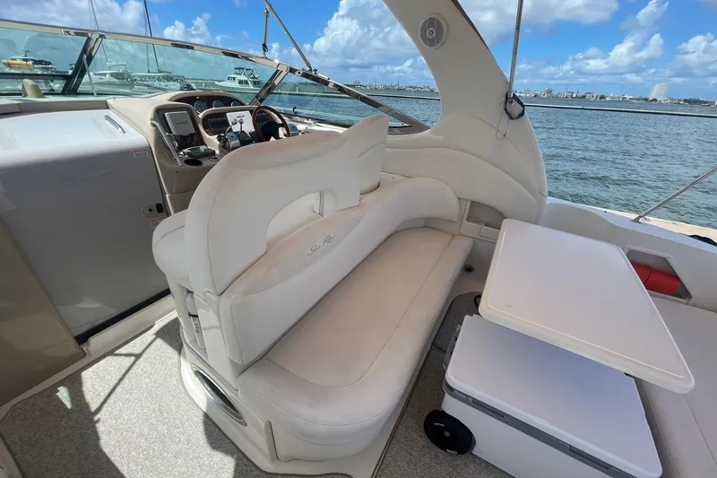 Slide: The Image of Interior of a 2003 Sea Ray 360 Sundancer yacht with seating and table, overlooking the water. - 10