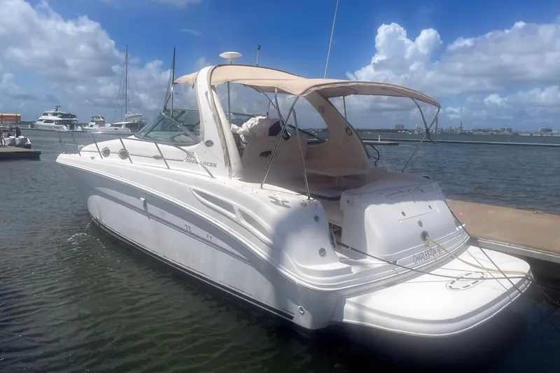 The Image of 2003 Sea Ray 360 Sundancer yacht docked at marina under blue sky. - 1