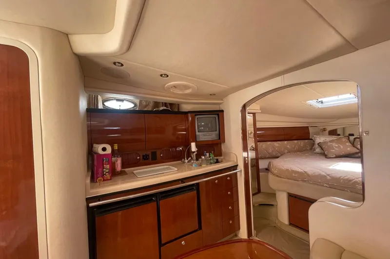 Slide: The Image of Interior of 2003 Sea Ray 360 Sundancer yacht with kitchenette and cozy sleeping area. - 22
