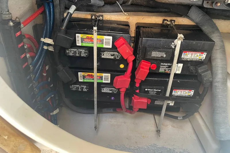 Slide: The Image of Battery compartment of a 2003 Sea Ray 360 Sundancer with multiple marine batteries. - 37