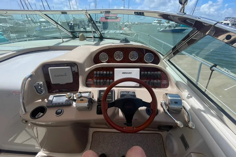 Slide: The Image of Cockpit view of 2003 Sea Ray 360 Sundancer with Garmin navigation system and Mercury controls. - 12