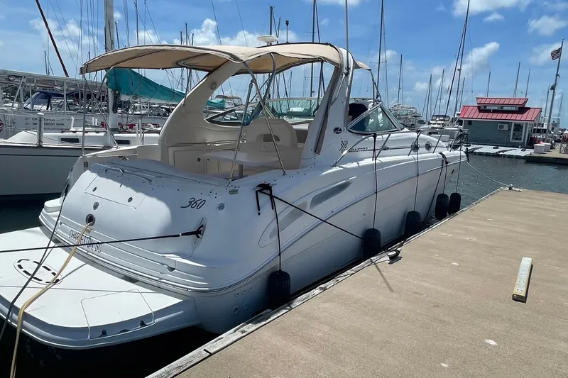 Slide: The Image of 2003 Sea Ray 360 Sundancer yacht docked at marina under clear blue sky. - 32