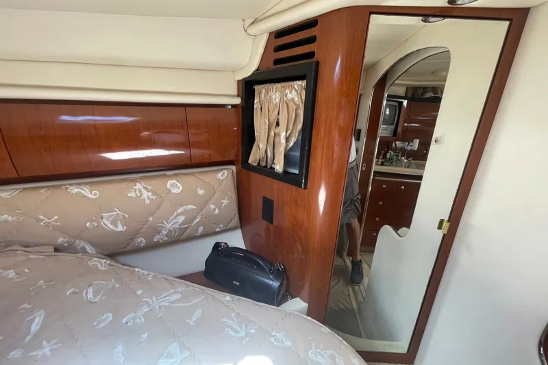 Slide: The Image of Interior of 2003 Sea Ray 360 Sundancer yacht, featuring elegant wood paneling and cozy cabin space. - 25