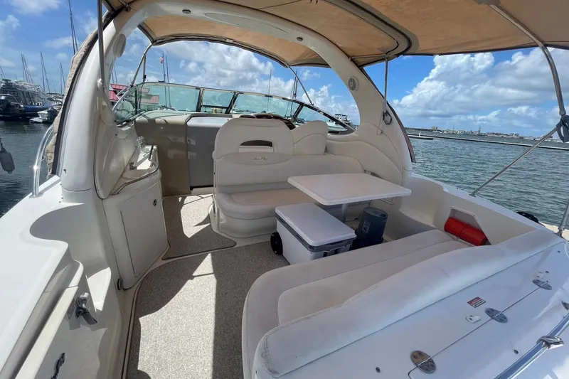 Slide: The Image of 2003 Sea Ray 360 Sundancer yacht interior with seating, table, and ocean view. - 8