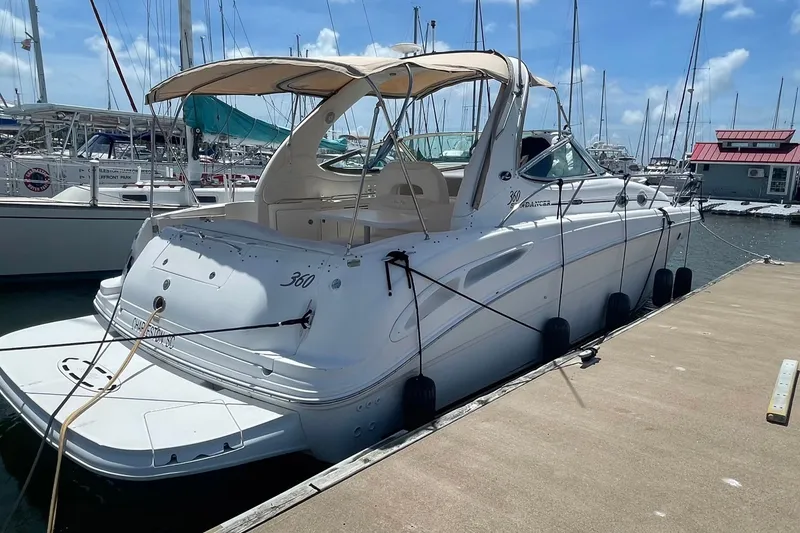 Slide: The Image of 2003 Sea Ray 360 Sundancer yacht docked at marina under clear blue sky. - 5