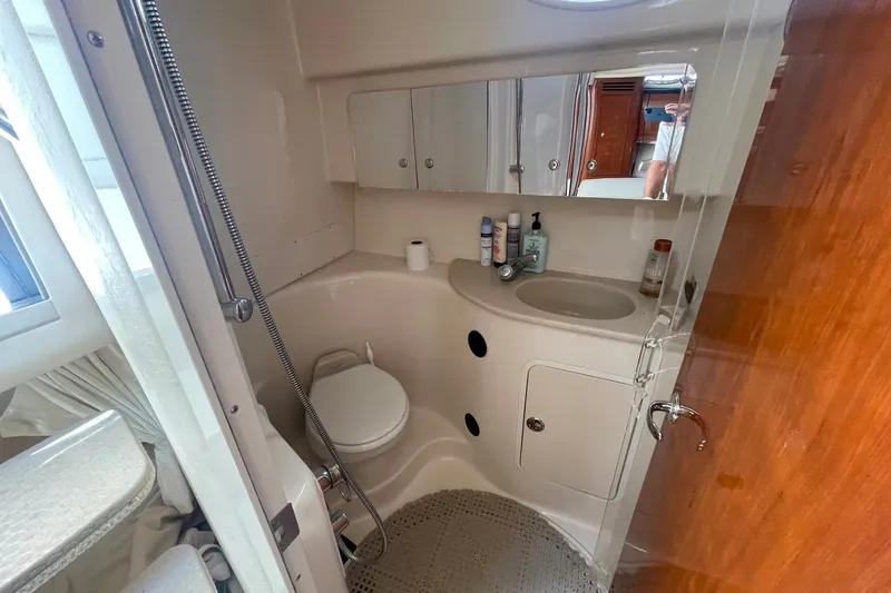 Slide: The Image of Bathroom interior of 2003 Sea Ray 360 Sundancer yacht, featuring sink, toilet, and shower. - 31