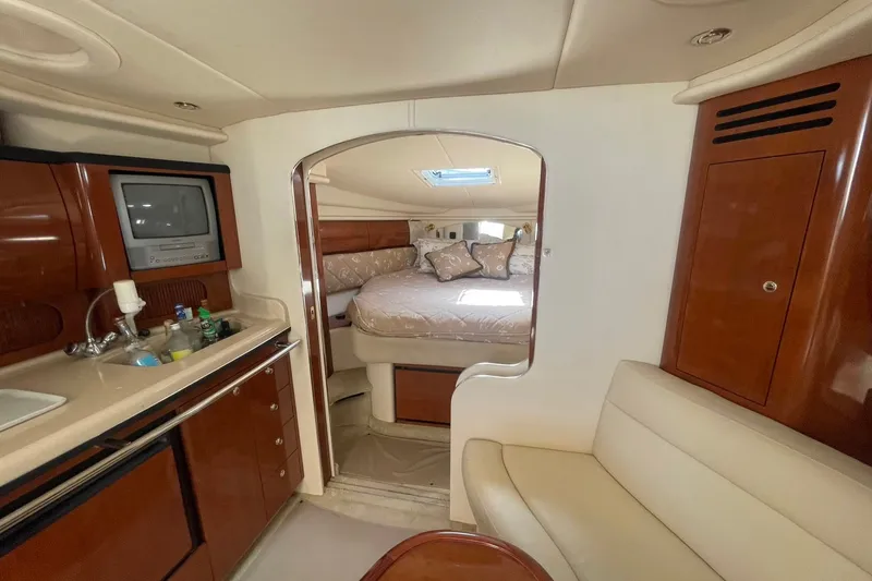 Slide: The Image of 2003 Sea Ray 360 Sundancer interior with cozy cabin, kitchenette, and seating area. - 20