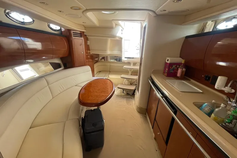 Slide: The Image of Interior of 2003 Sea Ray 360 Sundancer yacht with elegant seating and kitchenette. - 26