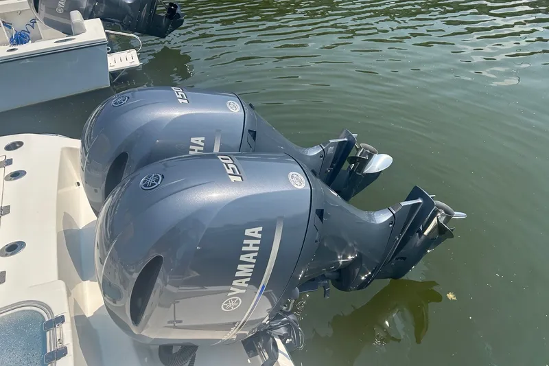 Slide: The Image of Twin Yamaha 150 engines on a 2024 Cobia 240 Center Console boat in water. - 12