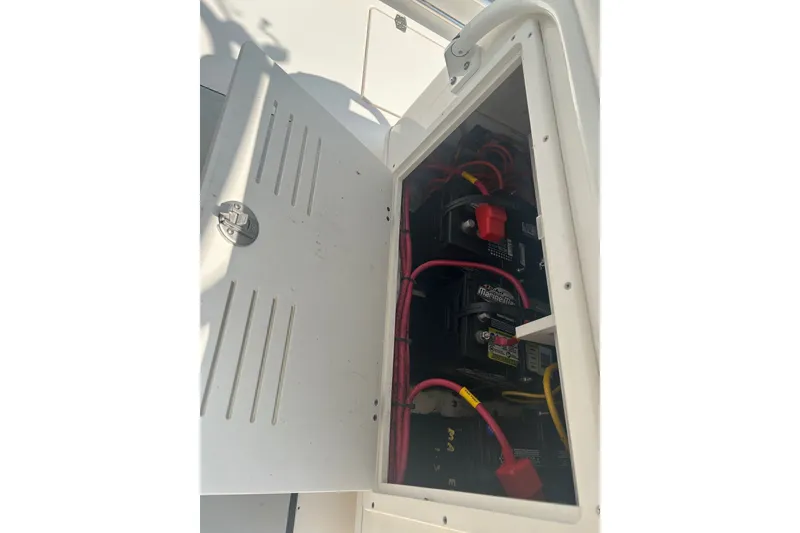 Slide: The Image of Battery compartment of 2024 Cobia 240 Center Console boat with wiring visible. - 13
