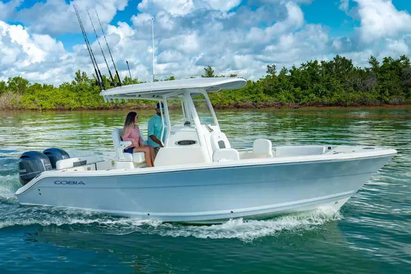 Slide: The Image of Manufacturer Provided Image: 2024 Cobia 240 Center Console boat cruising on a sunny day. - 20