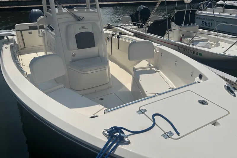 Slide: The Image of 2024 Cobia 240 Center Console boat docked, showcasing spacious seating and sleek design. - 5