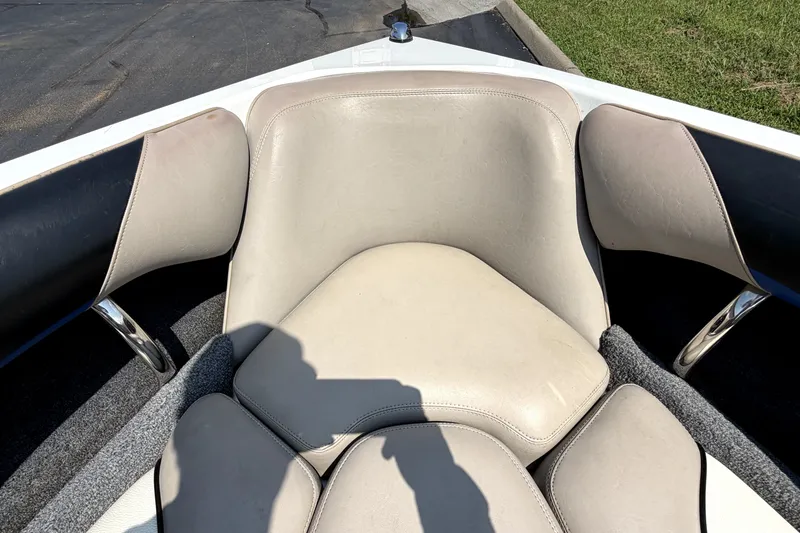Slide: The Image of Interior seating of a 2008 Malibu iRide boat, featuring beige and black upholstery. - 33