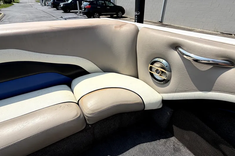 Slide: The Image of 2008 Malibu iRide boat interior with beige and blue seating, speaker, and chrome handle. - 17