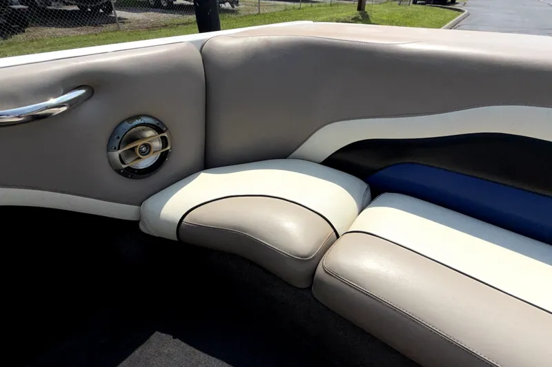 Slide: The Image of 2008 Malibu iRide boat interior with beige and blue cushioned seating and speaker. - 16