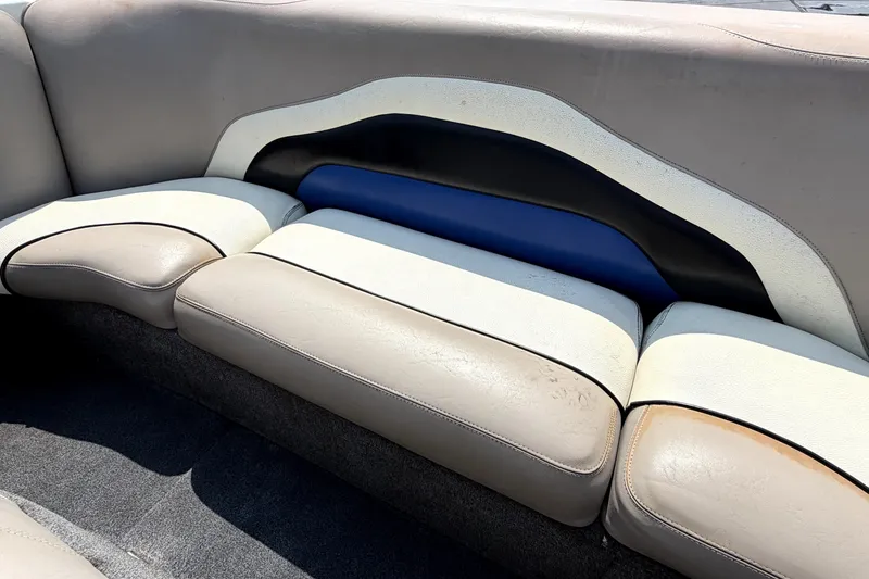 Slide: The Image of 2008 Malibu iRide boat interior with beige and blue cushioned seating. - 14