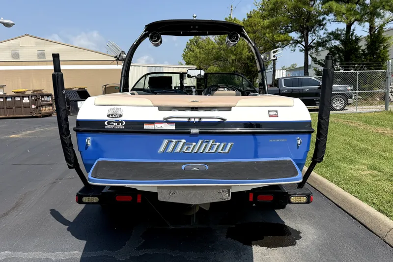 Slide: The Image of Rear view of a 2008 Malibu iRide boat in a parking area. - 7