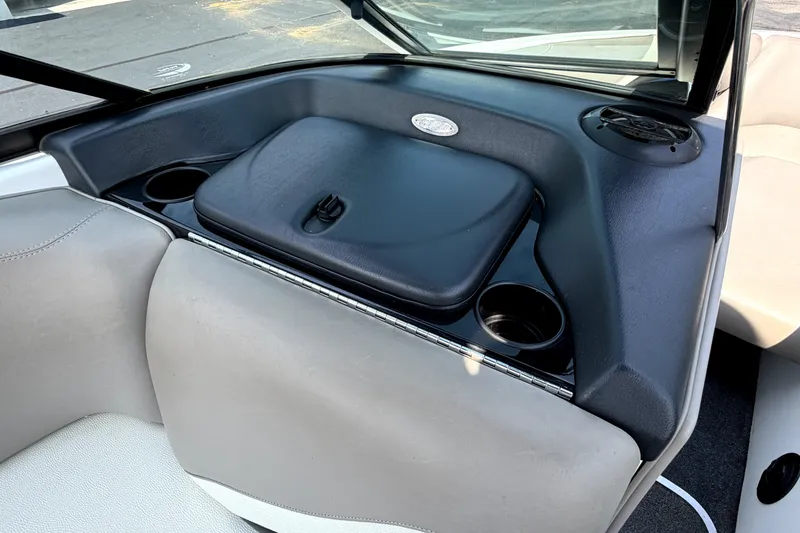Slide: The Image of 2008 Malibu iRide boat interior with cup holders and storage compartment. - 30