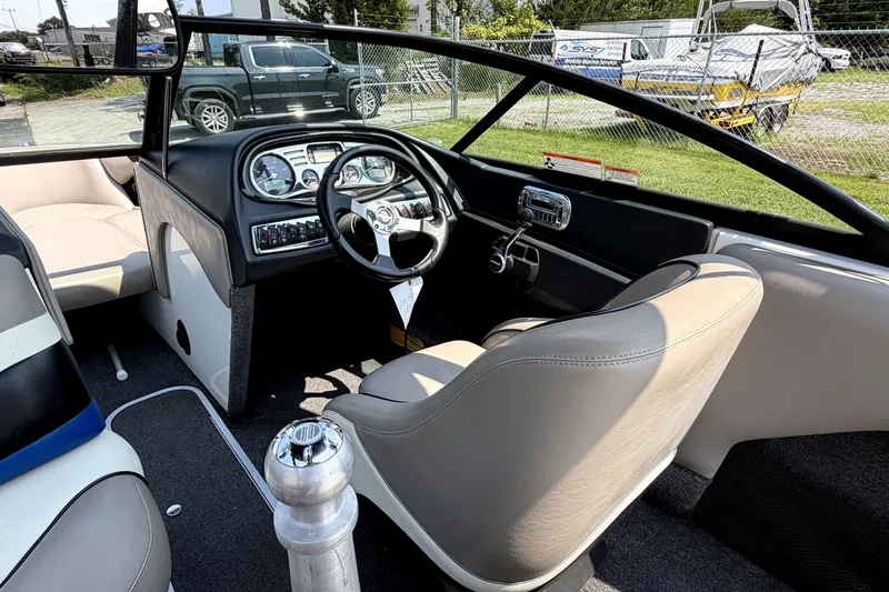 Slide: The Image of Interior of a 2008 Malibu iRide boat, featuring steering wheel and dashboard controls. - 21