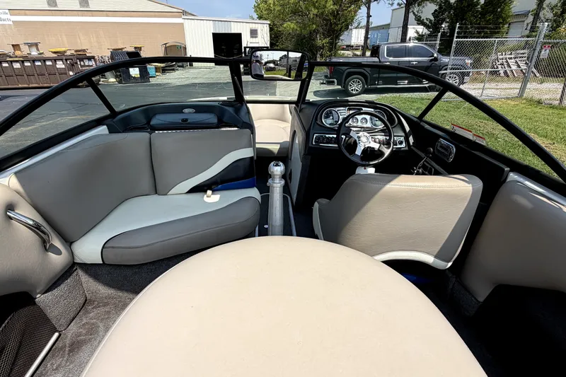 Slide: The Image of Interior of a 2008 Malibu iRide boat, featuring sleek seating and a modern dashboard. - 18
