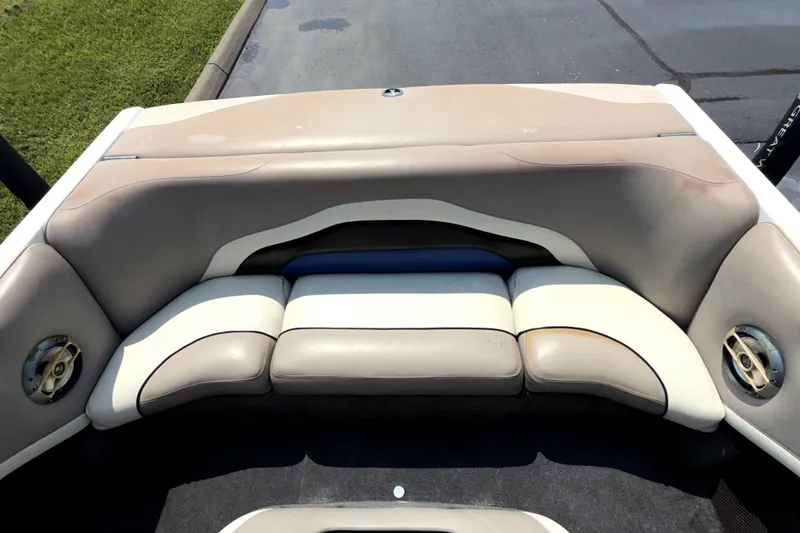 Slide: The Image of 2008 Malibu iRide boat interior with beige seating and built-in speakers. - 13