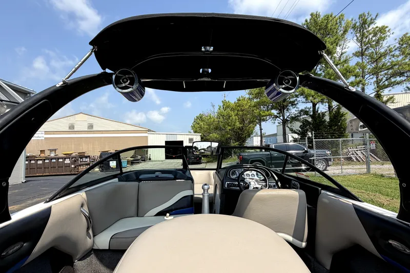 Slide: The Image of Interior view of a 2008 Malibu iRide boat with seating and dashboard. - 11