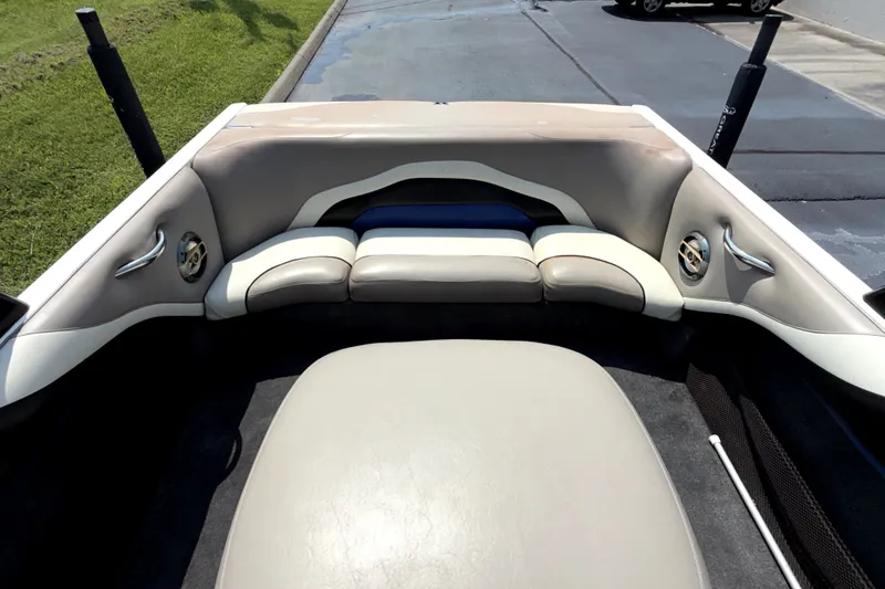 Slide: The Image of Interior of a 2008 Malibu iRide boat featuring beige seating and sleek design. - 12