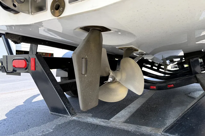 Slide: The Image of Underneath view of a 2008 Malibu iRide boat on a trailer, showing the propeller and rudder. - 42