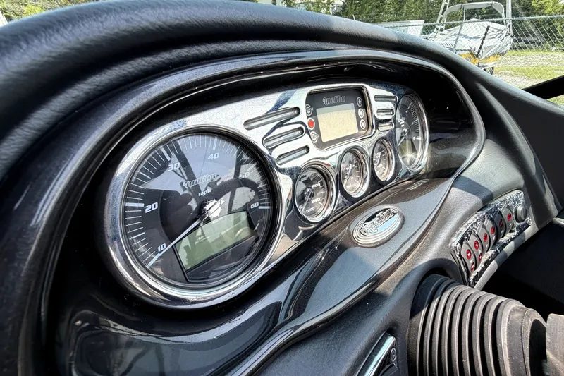 Slide: The Image of Dashboard of a 2008 Malibu iRide boat with gauges and controls. - 25