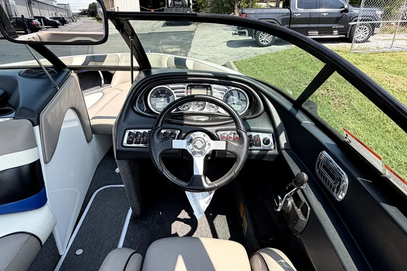 Slide: The Image of Interior view of a 2008 Malibu iRide boat dashboard with steering wheel and controls. - 23