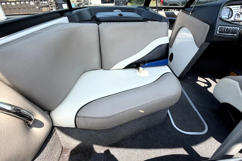 Slide: The Image of Interior of a 2008 Malibu iRide boat with beige and white seating. - 29
