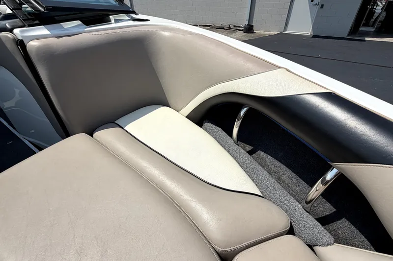 Slide: The Image of 2008 Malibu iRide boat interior with beige and black seating, showcasing sleek design. - 37