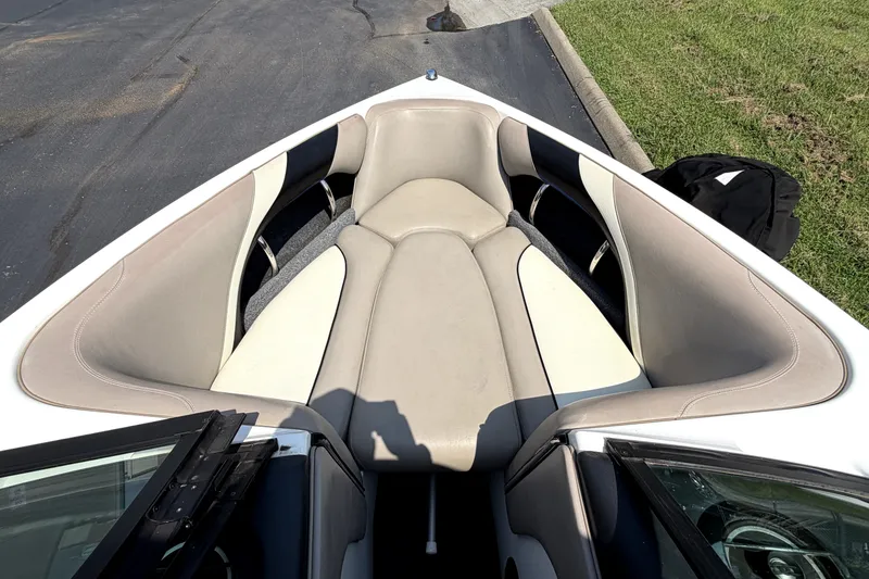 Slide: The Image of 2008 Malibu iRide boat interior with beige seating and open bow design. - 32