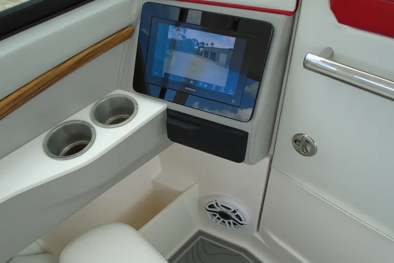Slide: The Image of 2024 Regal LX9 boat interior with touchscreen display, cup holders, and speaker system. - 19