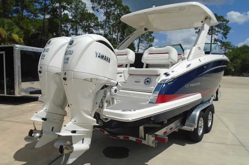 Slide: The Image of 2024 Regal LX9 boat with dual Yamaha engines on a trailer, parked outdoors. - 5