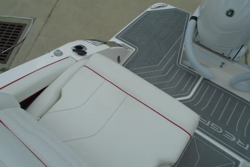 Slide: The Image of 2024 Regal LX9 boat interior with white seating and gray patterned flooring. - 24