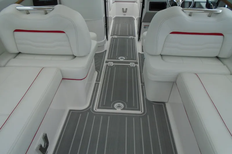 Slide: The Image of 2024 Regal LX9 boat interior with white seating and gray flooring. - 27