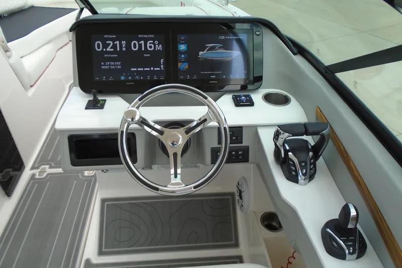 Slide: The Image of 2024 Regal LX9 boat dashboard with steering wheel, digital displays, and control panel. - 16