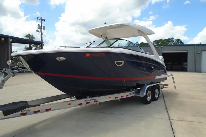 Slide: The Image of 2024 Regal LX9 boat on trailer, parked outdoors under a cloudy sky. - 3