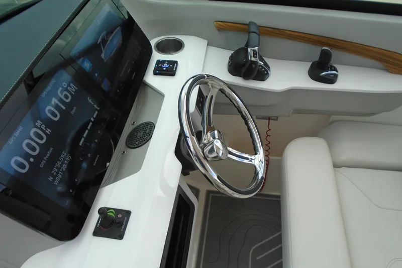 Slide: The Image of 2024 Regal LX9 boat dashboard with steering wheel, digital display, and controls. - 18