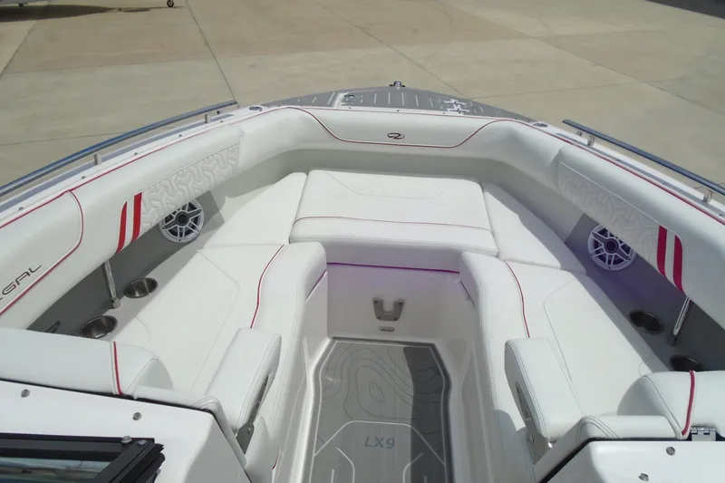 Slide: The Image of 2024 Regal LX9 boat interior with white seating and red accents. - 10