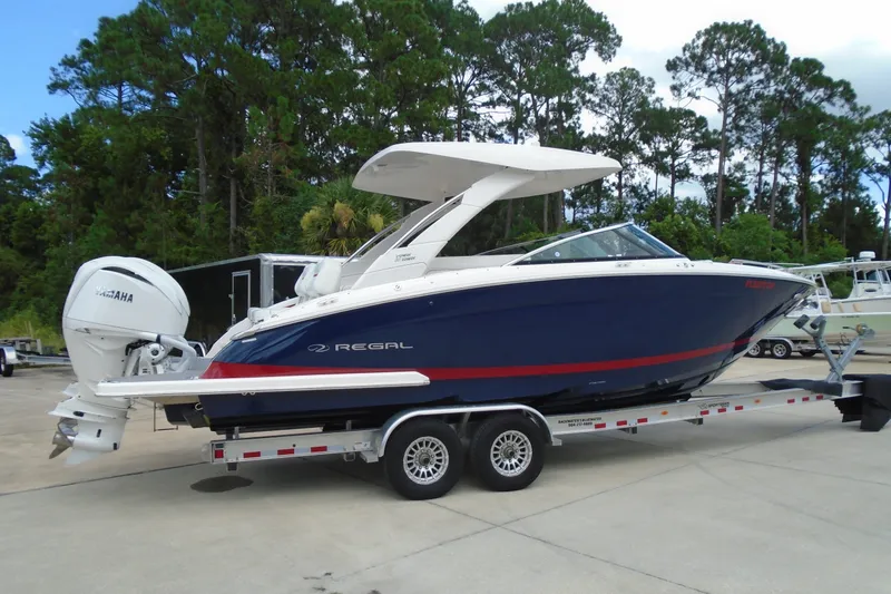 The Image of 2024 Regal LX9 boat on trailer, featuring sleek design and Yamaha engine. - 0