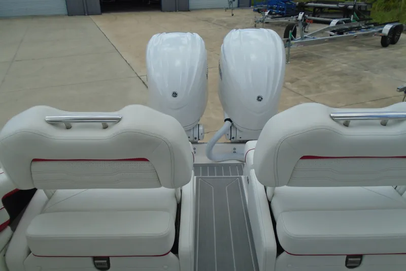 Slide: The Image of 2024 Regal LX9 boat with dual outboard engines and luxurious white seating. - 21