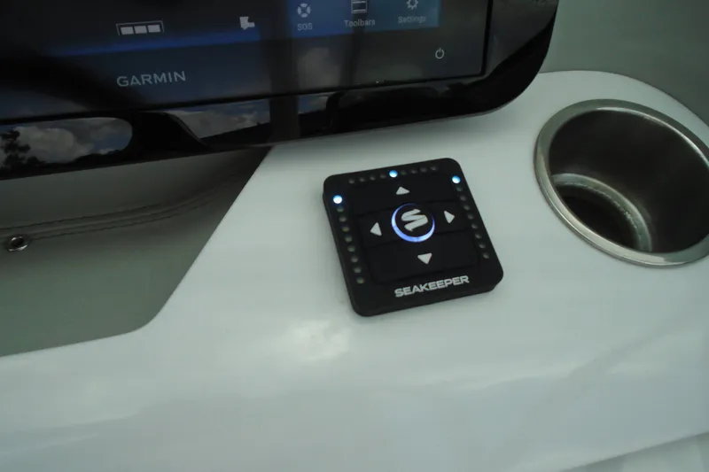 Slide: The Image of Control panel of a 2024 Regal LX9 boat featuring Garmin and Seakeeper systems. - 17