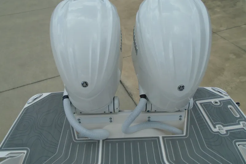 Slide: The Image of 2024 Regal LX9 boat with dual outboard motors on a textured deck. - 25