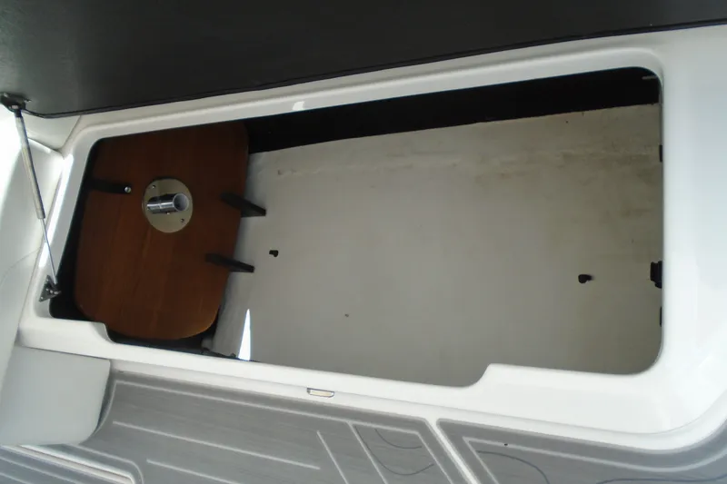 Slide: The Image of Storage compartment in 2024 Regal LX9 boat, featuring a wooden table and sleek design. - 7