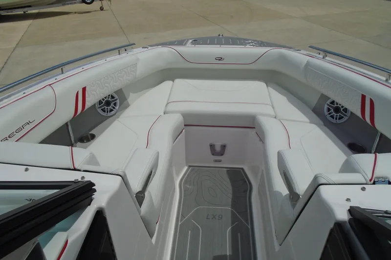 Slide: The Image of 2024 Regal LX9 boat interior with white seating and red accents. - 12