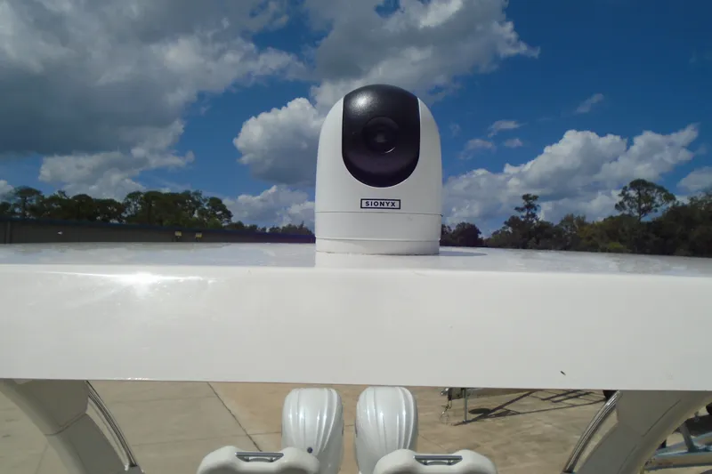 Slide: The Image of 2024 Regal LX9 boat with mounted SIONYX camera under a partly cloudy sky. - 28